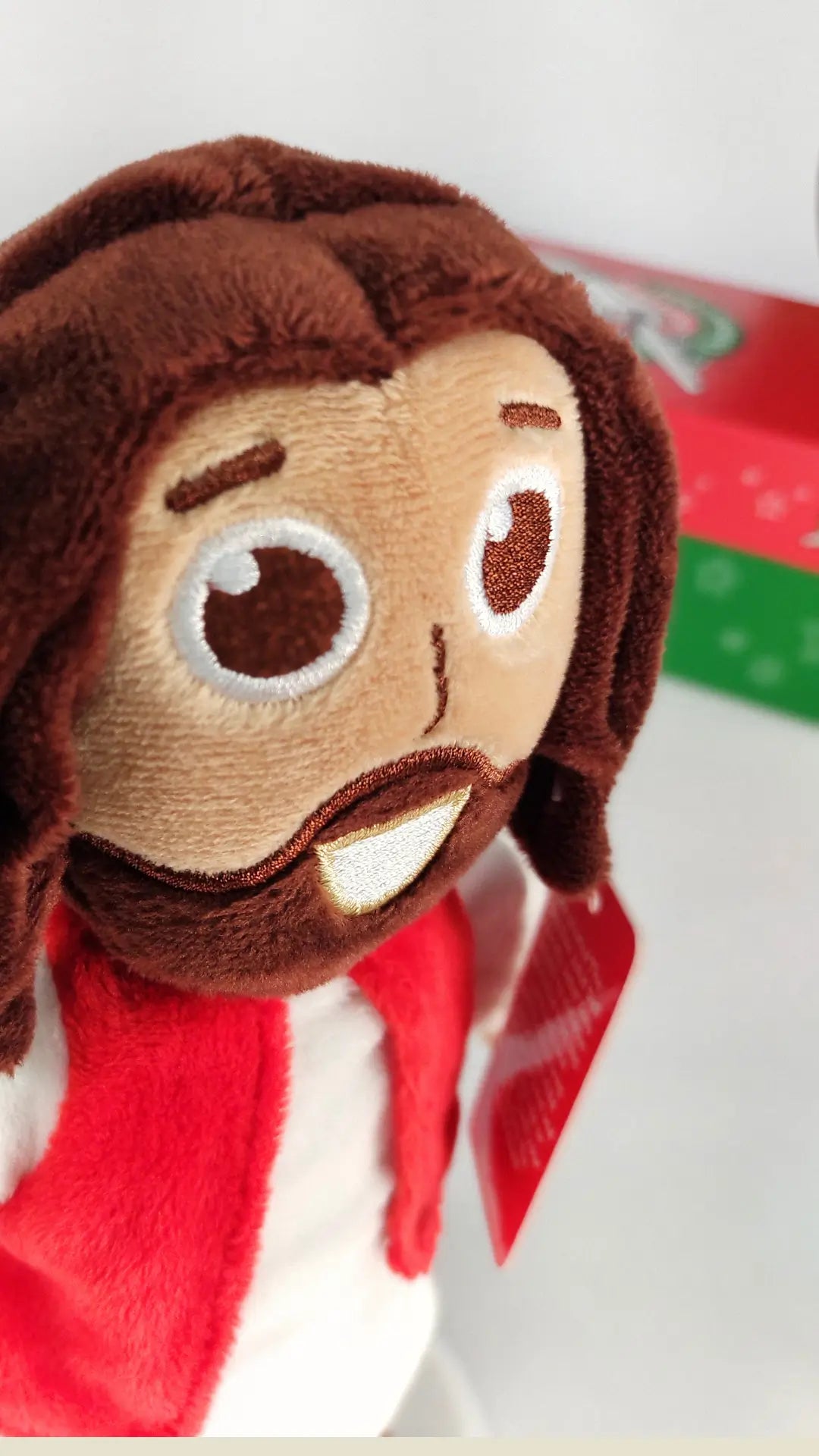 This plush Jesus has embroidered features for safety. 