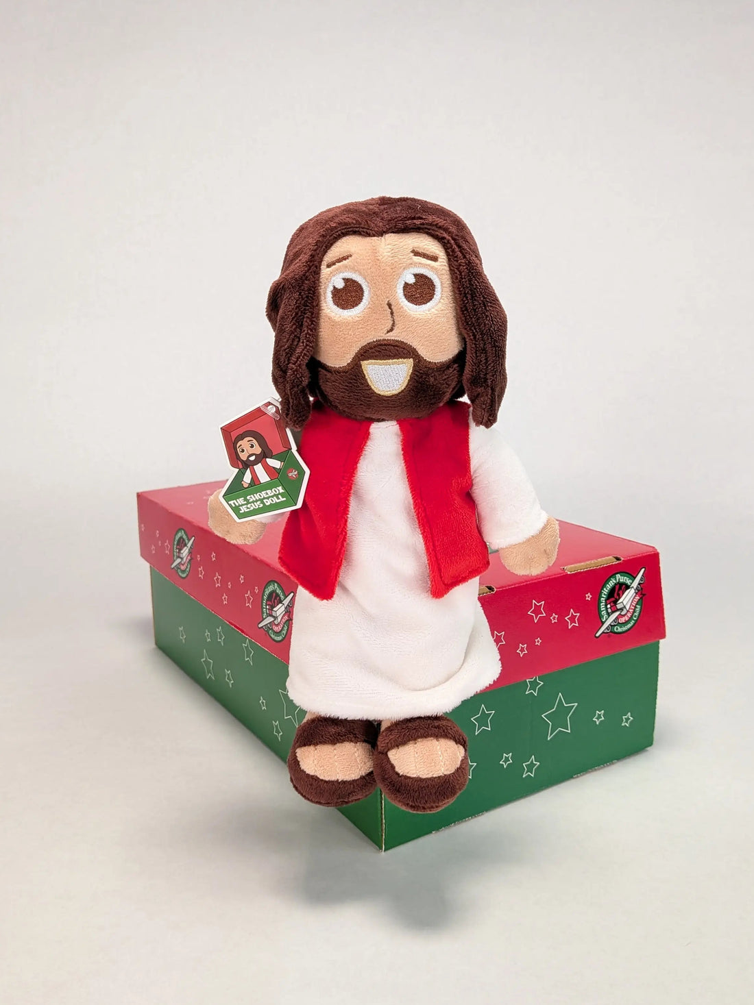 The Shoebox Jesus Doll sits on an Operation Christmas Child shoebox.  A perfect WOW gift for shoebox donations.