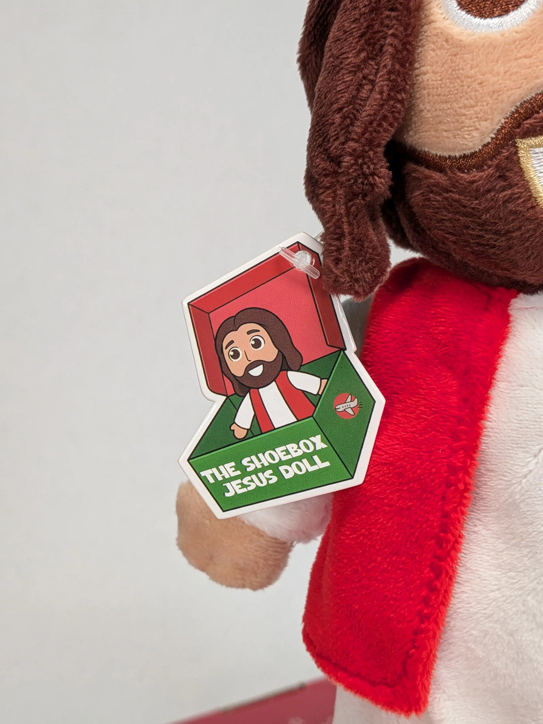 Close up of the Shoebox Jesus Doll featuring the new tag (2026) - only from Jesusdoll.com