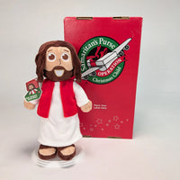 The Shoebox Jesus Doll, a plush Jesus toy from Jesusdoll.com, standing next to a Samaritan's Purse Operation Christmas Child shoebox.