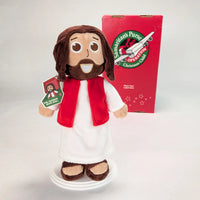 The Shoebox Jesus Doll from Jesusdoll.com with an Operation Christmas Child shoebox in the background.