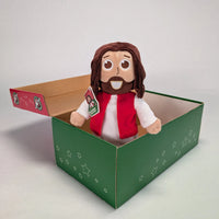 The Shoebox Jesus Doll from Jesusdoll.com sits in an Operation Christmas Child shoebox.