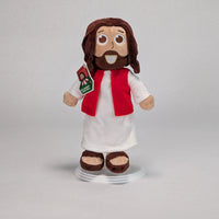 The Shoebox Jesus Doll, a plush Jesus toy from Jesusdoll.com standing in front of a light grey backgroud.