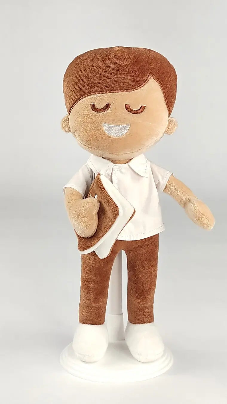 BibleBoy plush boy doll with buttoned up shirt and slacks holds his Bible .